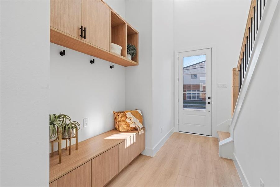 This entryway sets the tone for the rest of the home with its refined aesthetic and practical design. Featuring sleek cabinetry and ample shelving, it offers the perfect balance of elegance and organization, creating a welcoming and clutter-free space from the moment you step inside.