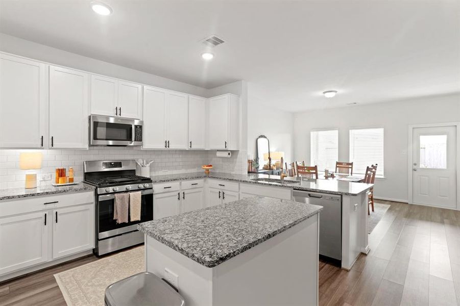 Explore the seamless flow of this modern kitchen into the inviting dining space, perfect for entertaining and everyday living.