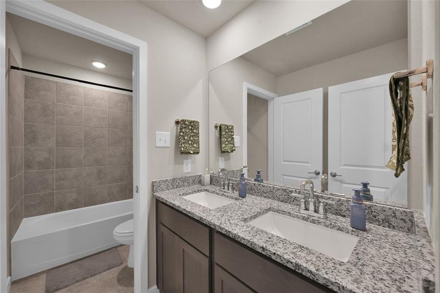 A double sink vanity provides plenty of counter space and storage in the upstairs third bathroom.