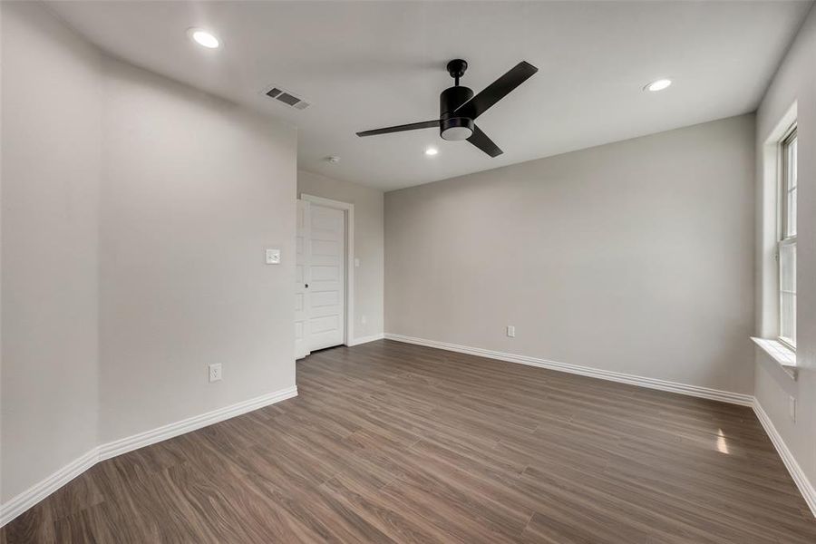 Spare room with ceiling fan and dark hardwood / wood-style flooring
