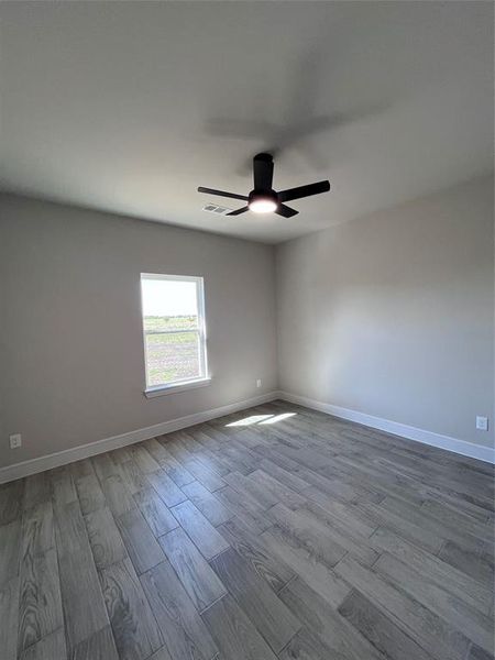 Unfurnished room featuring light hardwood / wood-style floors and ceiling fan