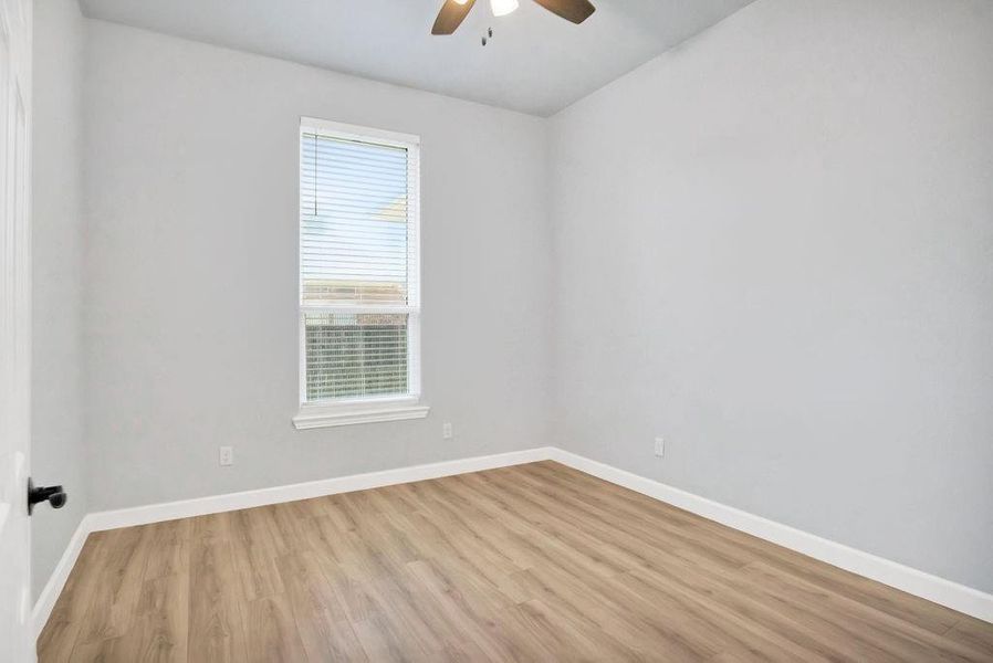 Spare bedroom with ample closet space, ceiling fan and high ceilings!