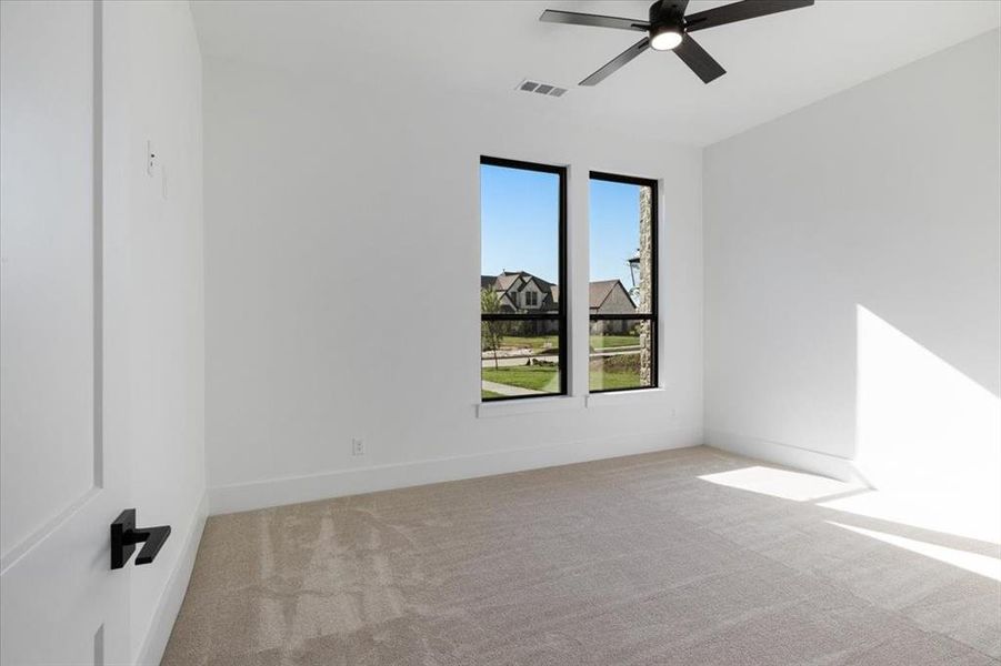 Spare room with carpet floors and ceiling fan