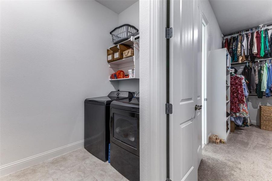 Full sized laundry room with mud cabinet