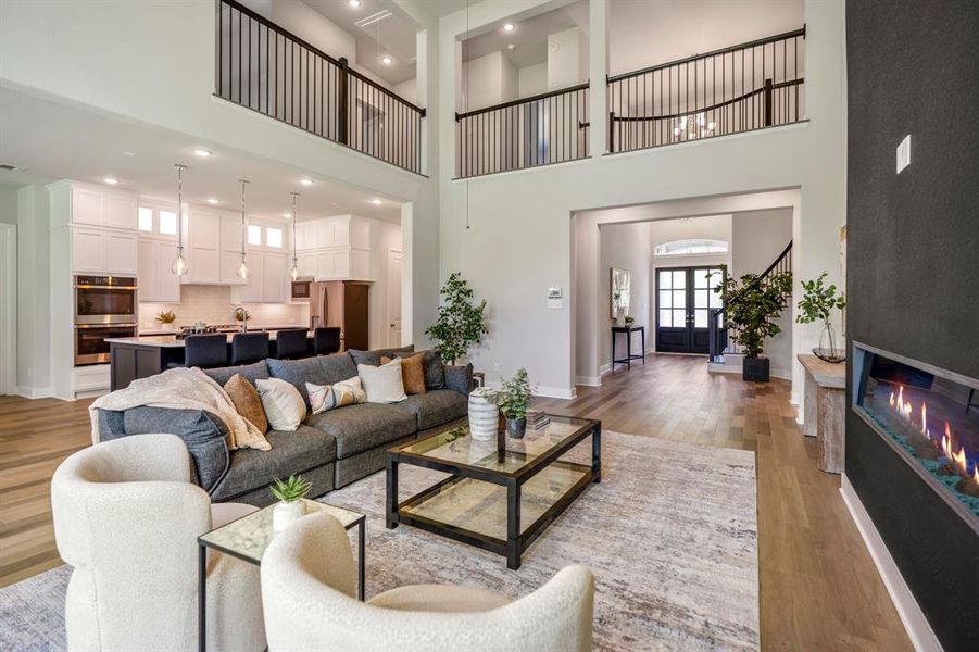 The soaring ceilings and open layout create a grand living space perfect for modern family life.