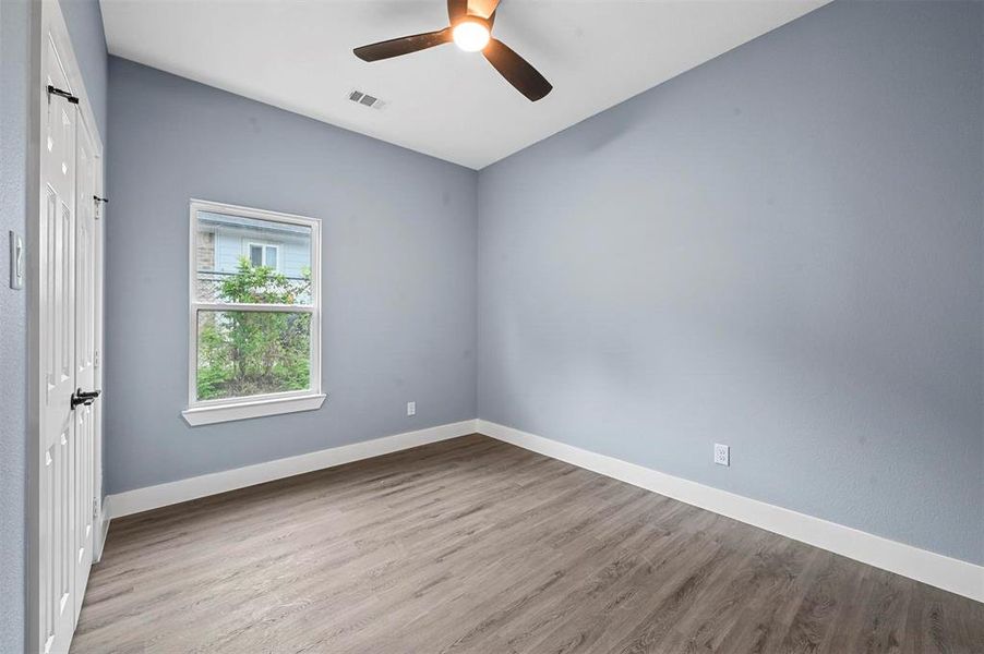 Empty room with light hardwood / wood-style flooring and ceiling fan