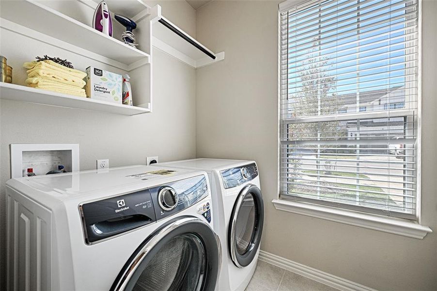 Full size utility room with extra storage shelves and drip-dry hanging rod