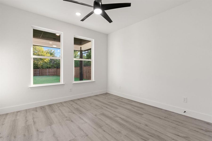 Spare room featuring ceiling fan and light hardwood / wood-style floors