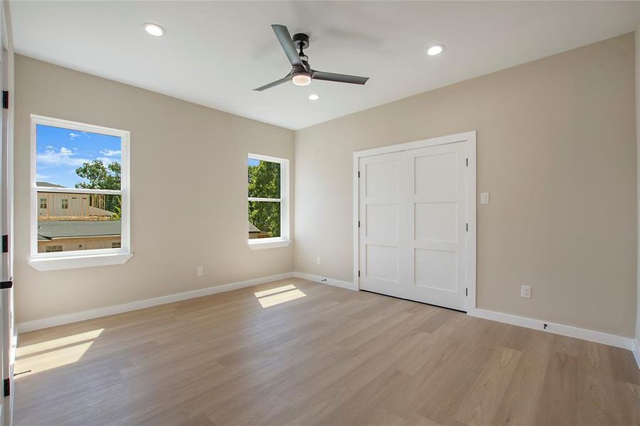 Unfurnished bedroom featuring ceiling fan and light hardwood / wood-style floors