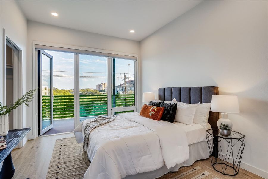 Spacious primary bedroom which looks out onto the expansive patio.