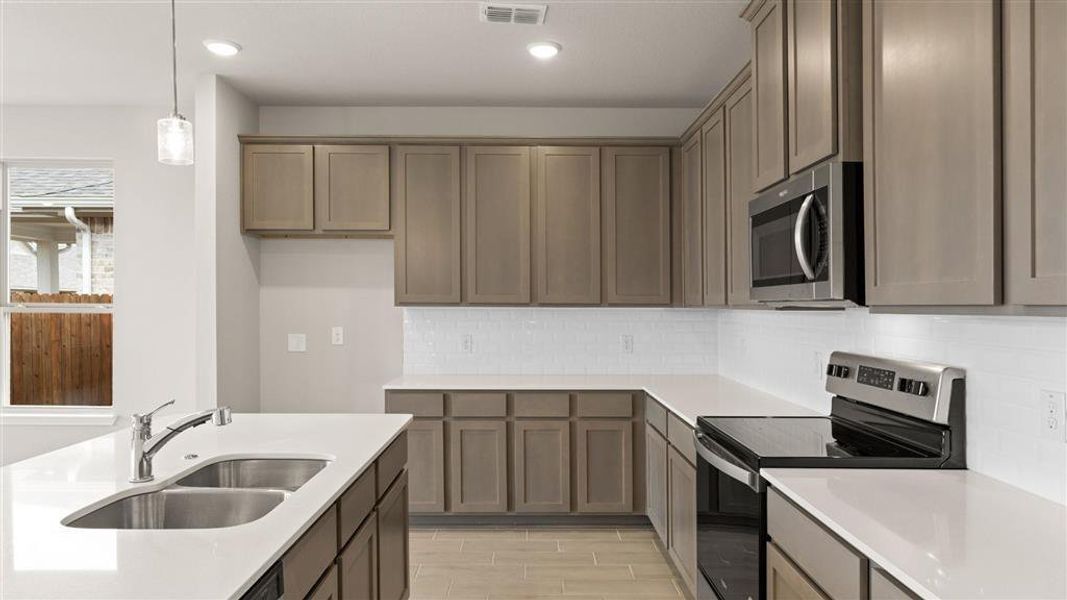 Kitchen w/ Granite Countertops and Ceramic Tile Backsplash