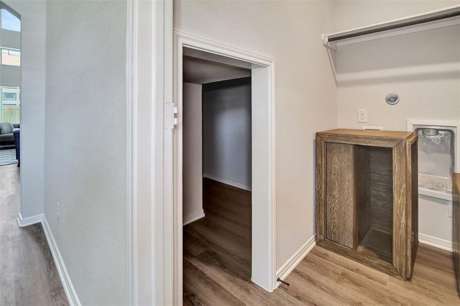 Downstairs laundry room has a great storage area under the stairs. Could make a great dog kennel.