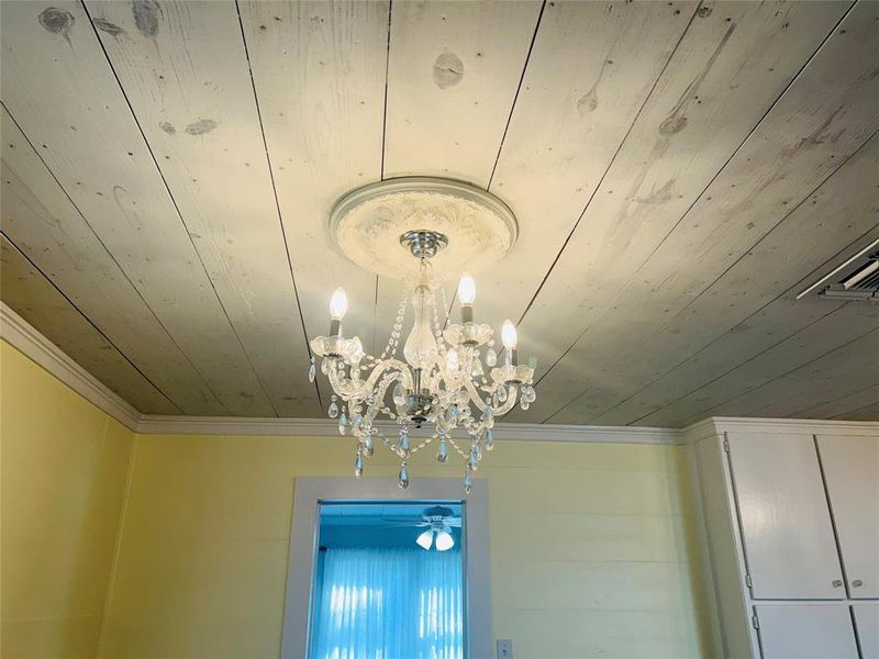 Room details with ornamental molding and an inviting chandelier