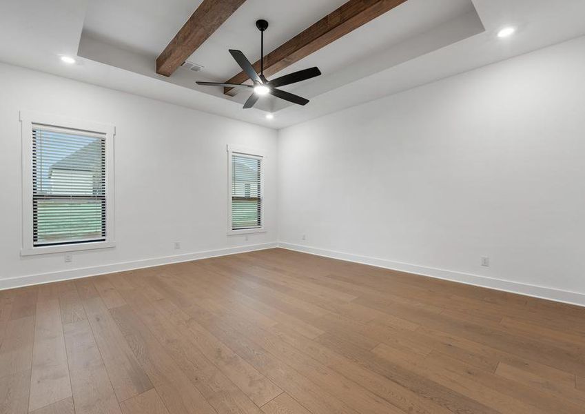 The peaceful master bedroom has two large windows that let in great, natural light.