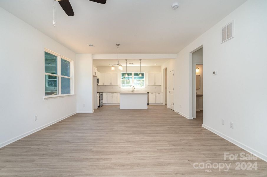 Representative Photo. Open living room into dining and kitchen