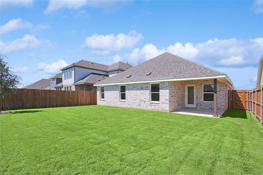 Rear view of house featuring a patio area and a yard