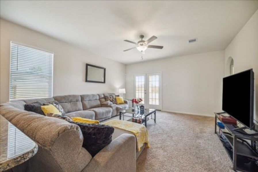 Living Room, French Doors which lead to the Covered Patio & Spacious Backyard