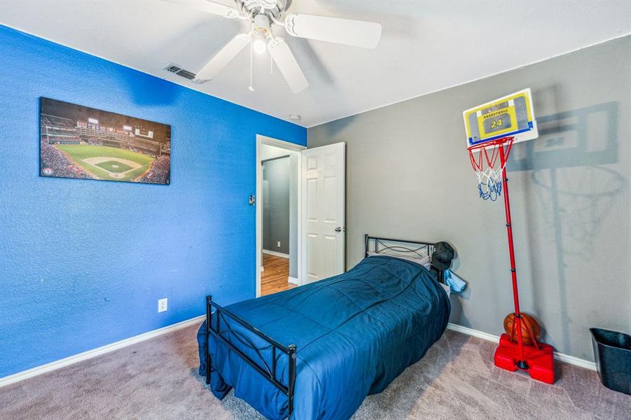 Carpeted bedroom with ceiling fan