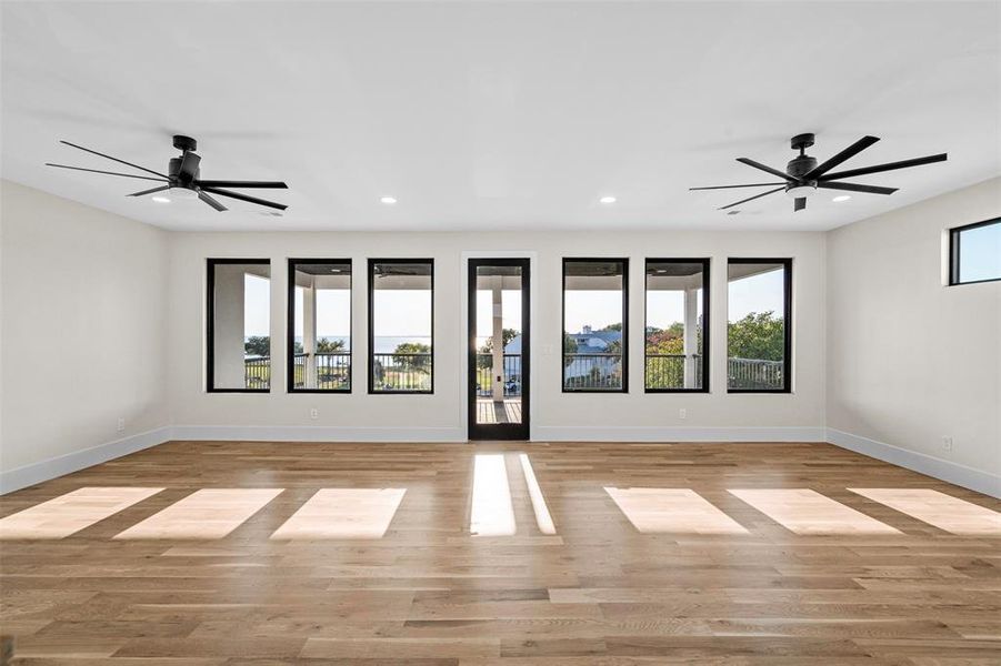 Unfurnished room featuring light wood-type flooring and ceiling fan