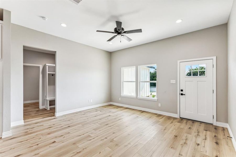 Entryway with ceiling fan and light hardwood / wood-style flooring