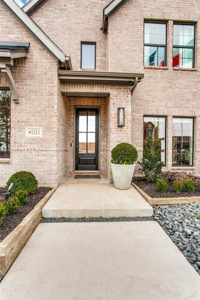 Featuring light colored brick paired with striking dark accents, this dream home offers tons of curb appeal!