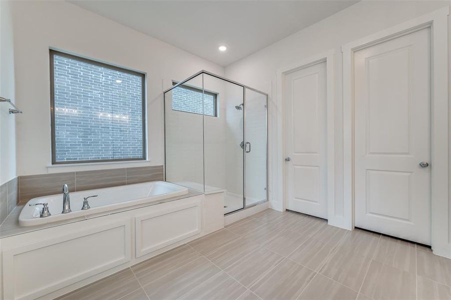 Bathroom featuring separate shower and tub and tile patterned floors