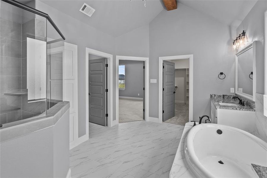 Bathroom with separate shower and tub, tile patterned floors, vaulted ceiling with beams, and vanity
