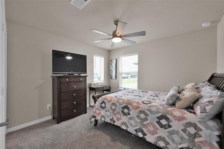 One of three generously sized upstairs bedrooms.  Notice the natural lighting and the newly installed ceiling fans in this room.