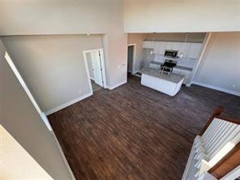 Unfurnished living room with dark wood-type flooring