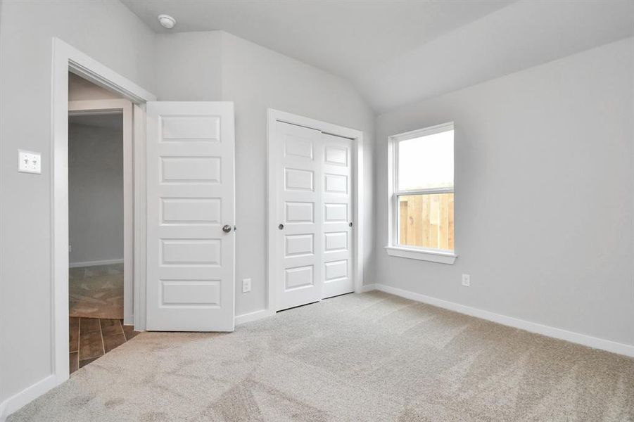 Generously sized secondary bedrooms featuring spacious closets, soft and inviting carpeting underfoot, large windows allowing plenty of natural light, and the added touch of privacy blinds for your personal retreat.