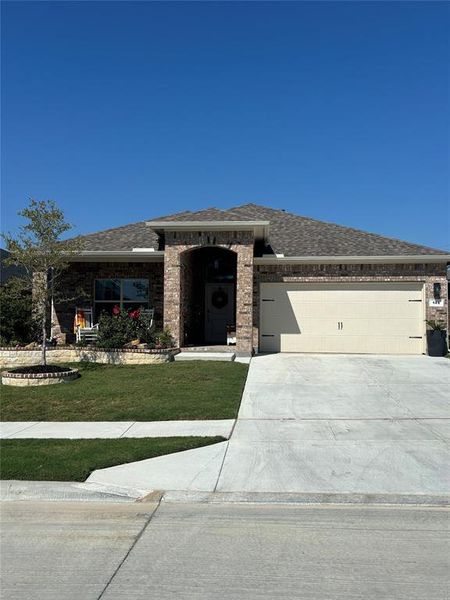 Prairie-style home with a front lawn and a garage