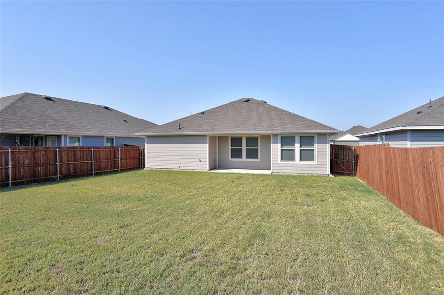 Rear view of house with a lawn