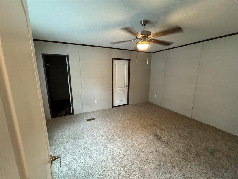 Unfurnished bedroom with carpet floors and ceiling fan