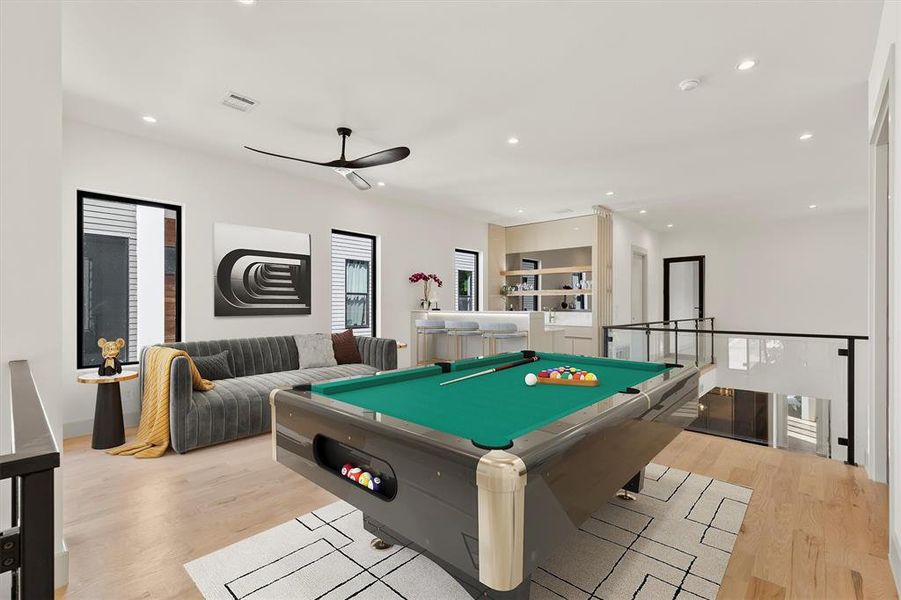 Recreation room with light wood-type flooring, ceiling fan, and billiards