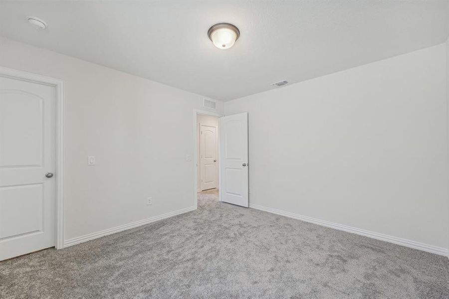 Spare room featuring light colored carpet