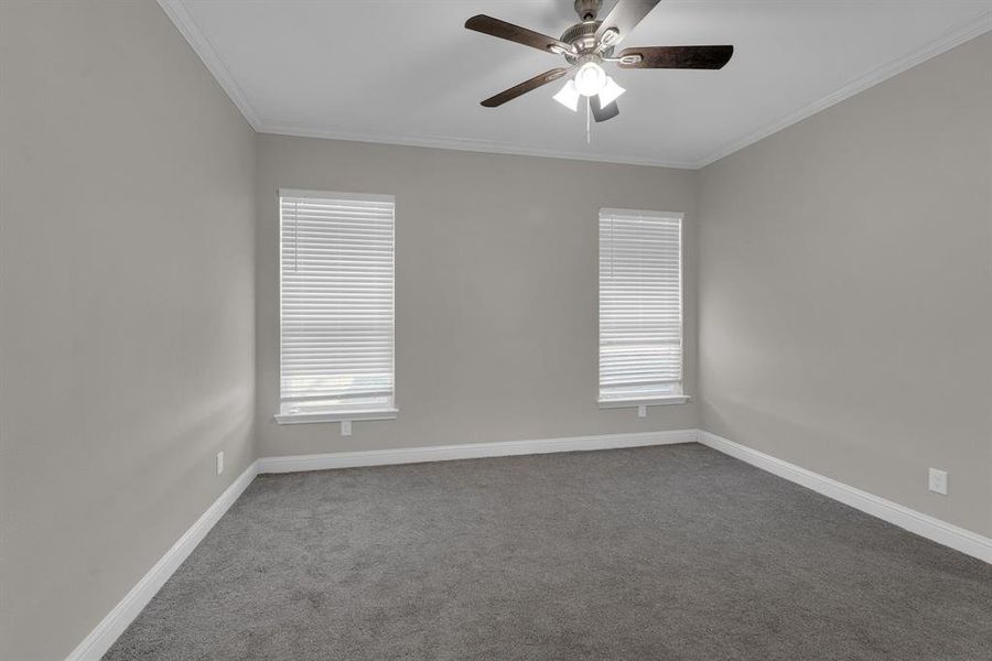 Bedroom with ornamental molding and ceiling fan