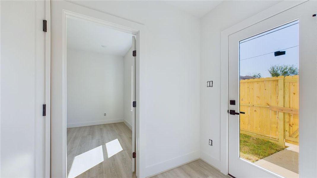 The side door provides easy access for both short-term rental guests and residents, leading directly to a spacious 32x8 private yard for added convenience