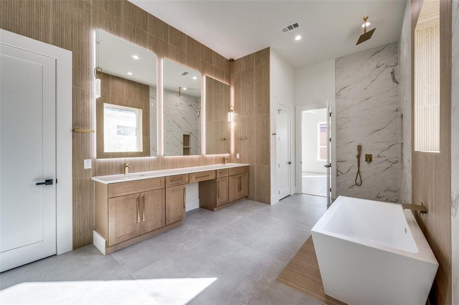 Bathroom featuring vanity, concrete floors, tile walls, and plus walk in shower