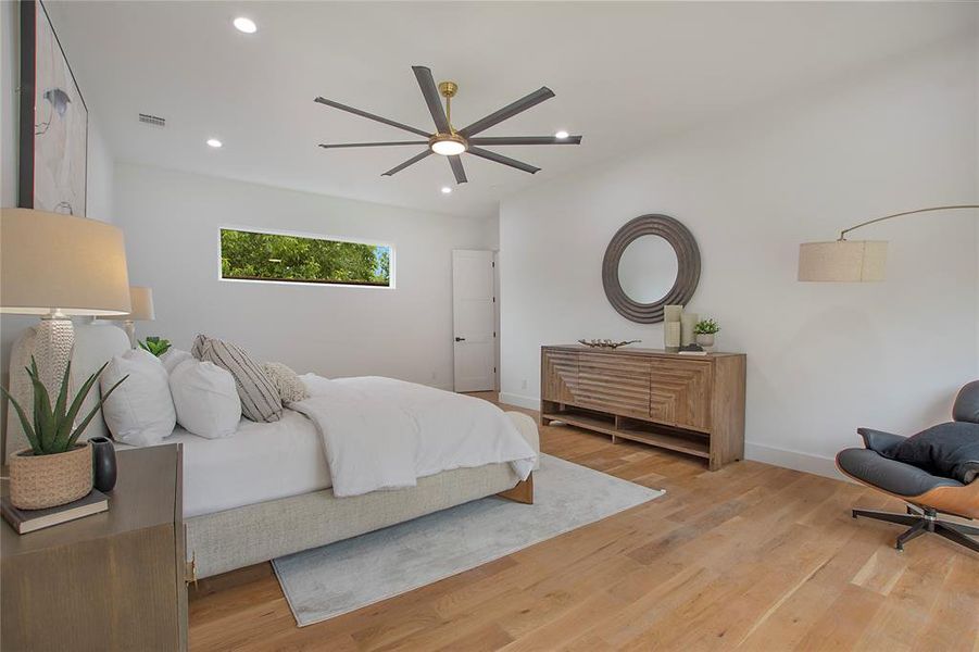 Bedroom with light hardwood / wood-style flooring and ceiling fan