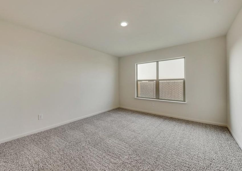 The master suite has brown carpet and light walls.