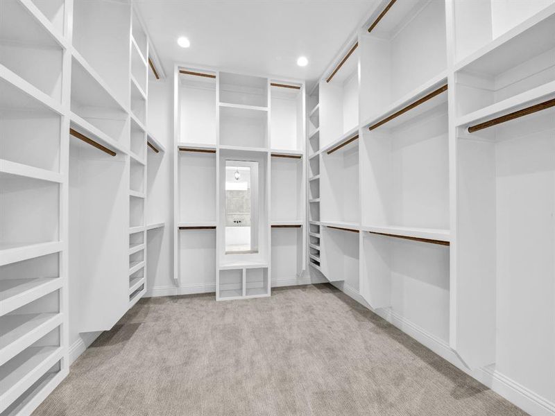 Walk in closet with light carpet