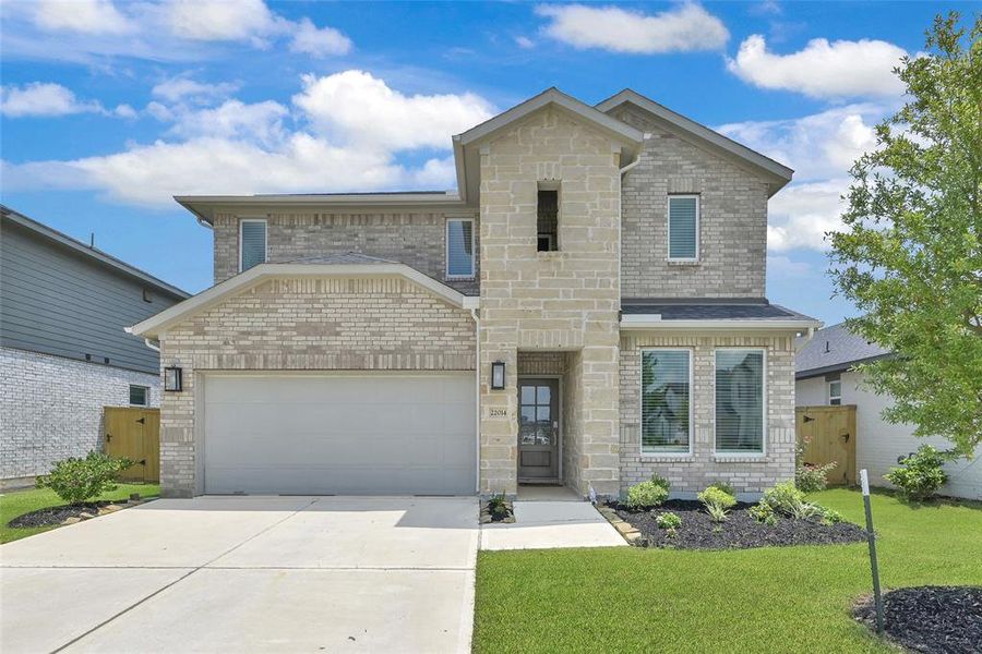 Welcome home to 22014 Big Sky Dr.  Your lovely 4 bedroom, 3 1/2 bathroom TaylorMorrison home showcasing an elegant brick and stone facade awaits.