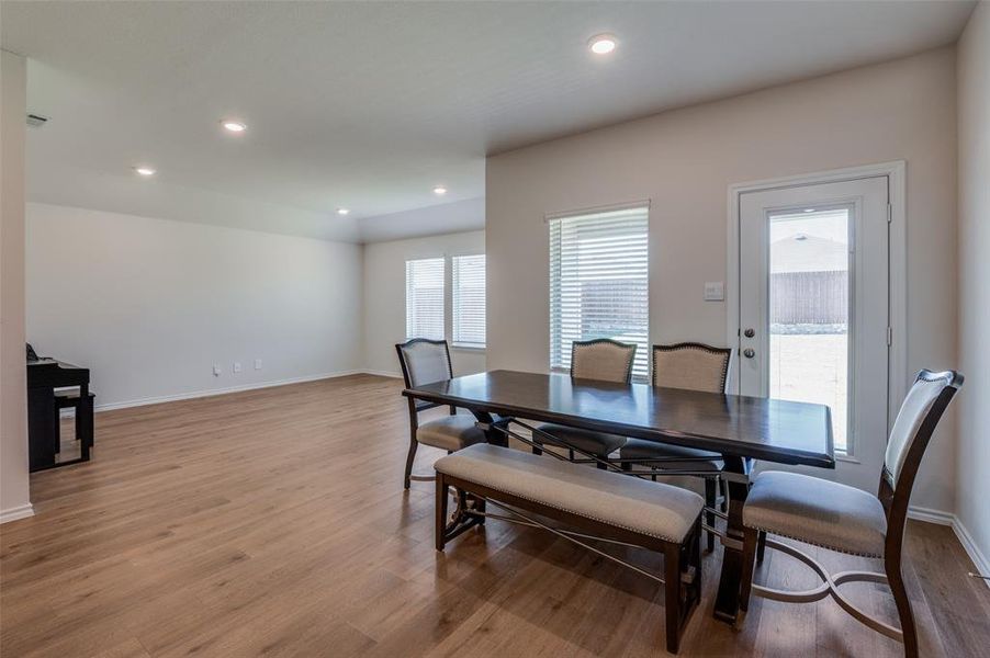 Dining space with light hardwood / wood-style floors and plenty of natural light