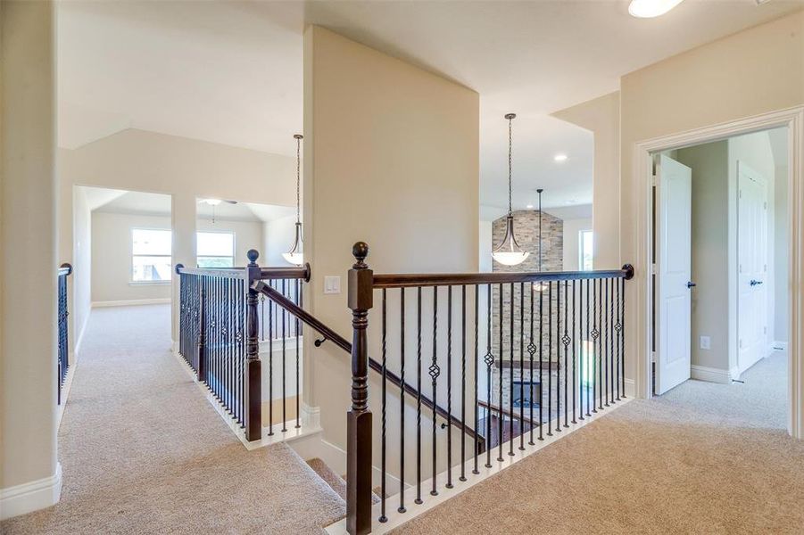 Corridor featuring light colored carpet