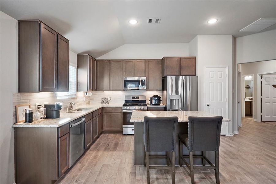 Island kitchen with granite countertops and stainless steel appliances!