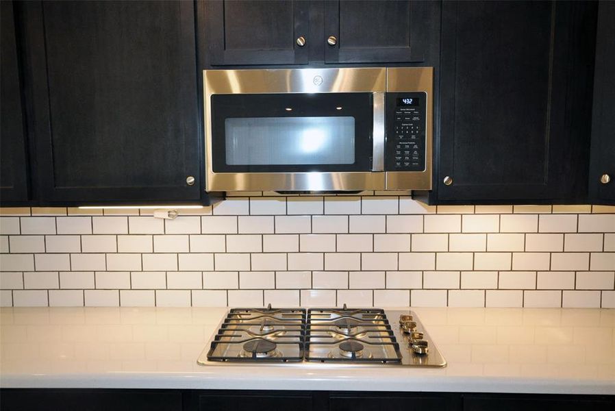 Gas cooktop and microwave built in above.