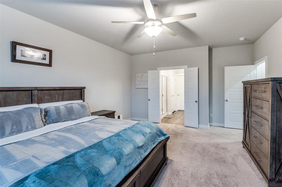 Bedroom featuring light carpet and ceiling fan