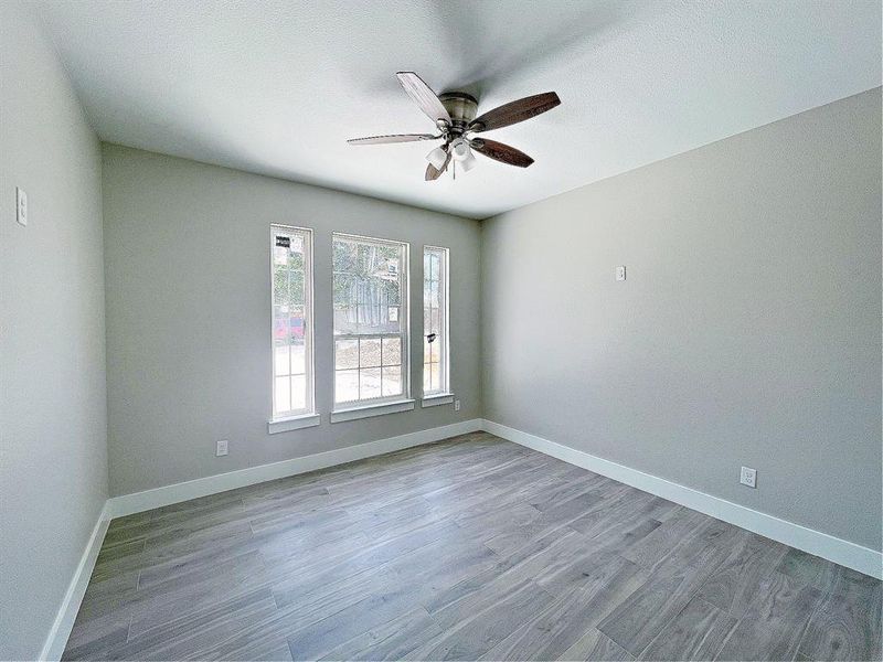 This bedroom is located facing the front of the home and would make a great office or room for guests