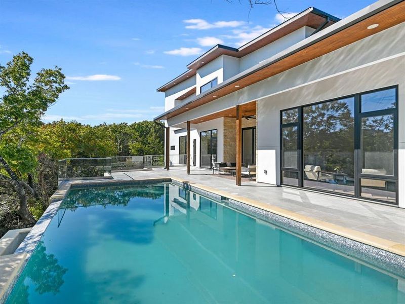 540sf covered deck with outdoor kitchen overlooking the pool.