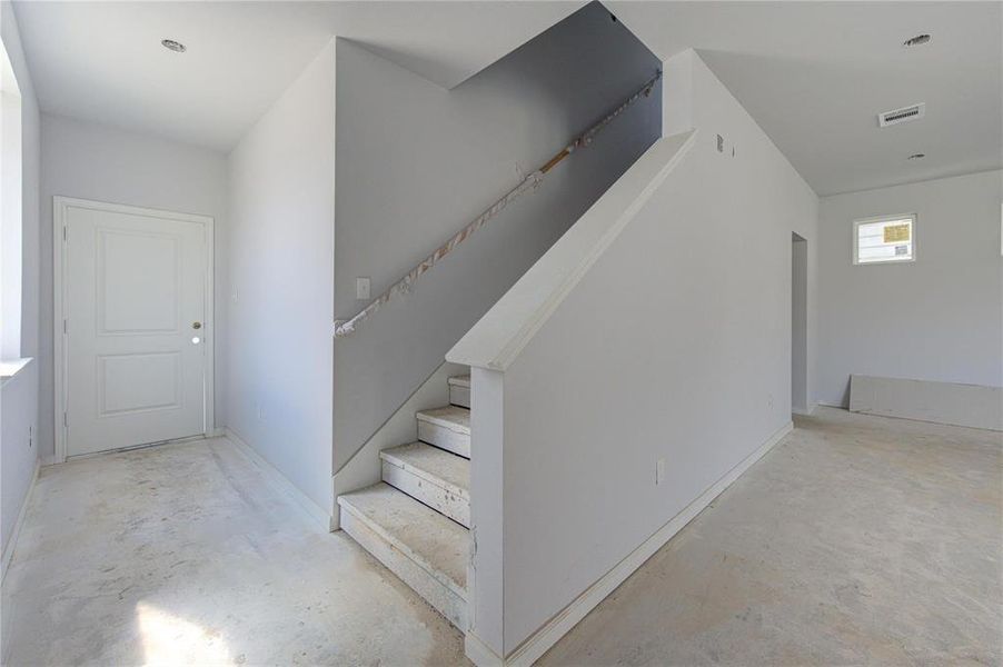 This inviting staircase leads to the upper level of the Athena floor plan, designed to seamlessly connect both floors while maintaining a sense of privacy for the upstairs bedrooms. The clean lines and modern finishes enhance the open and airy feel of this beautiful new construction. **This image is from another Saratoga Home - Athena floorplan.**